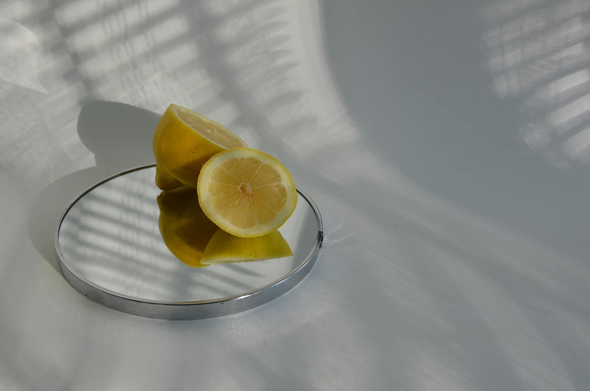Three fresh lemons arranged on a white plate, symbolizing restored vitality and sensation