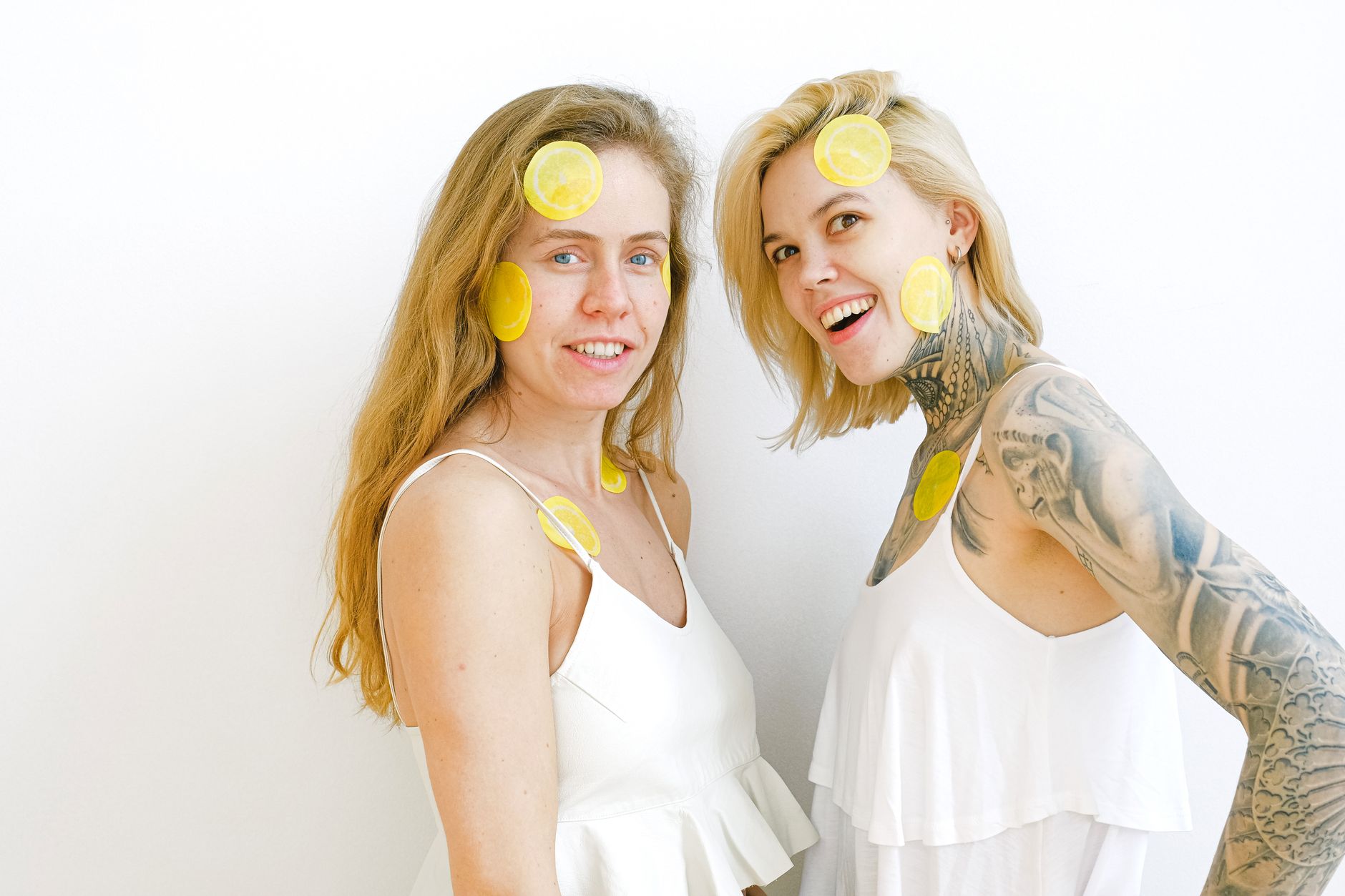 A hand holding a lemon against a bright yellow background, symbolizing fresh sensation and renewal