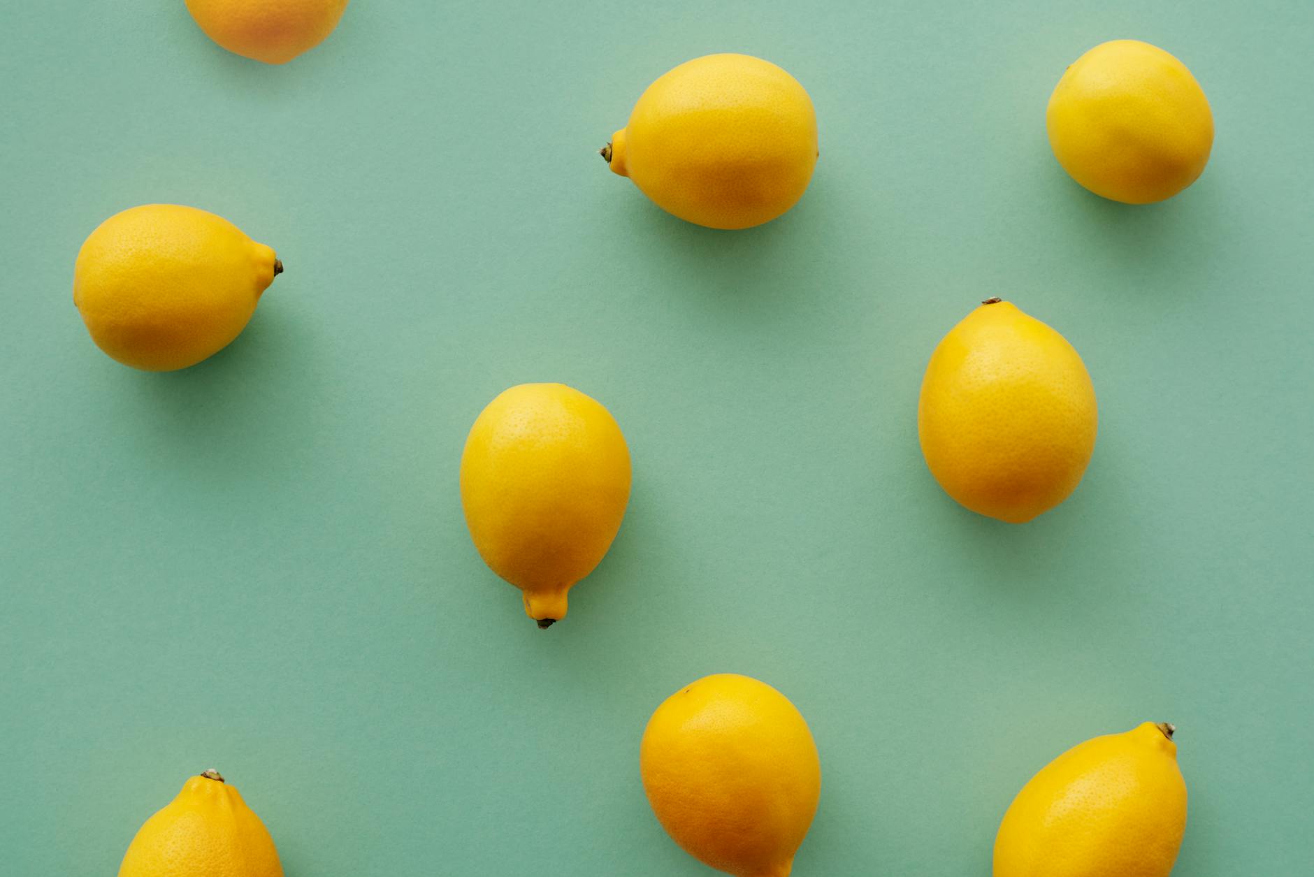 Bright yellow lemons on a pastel background, representing the refreshing clarity that comes from addressing medication side effects