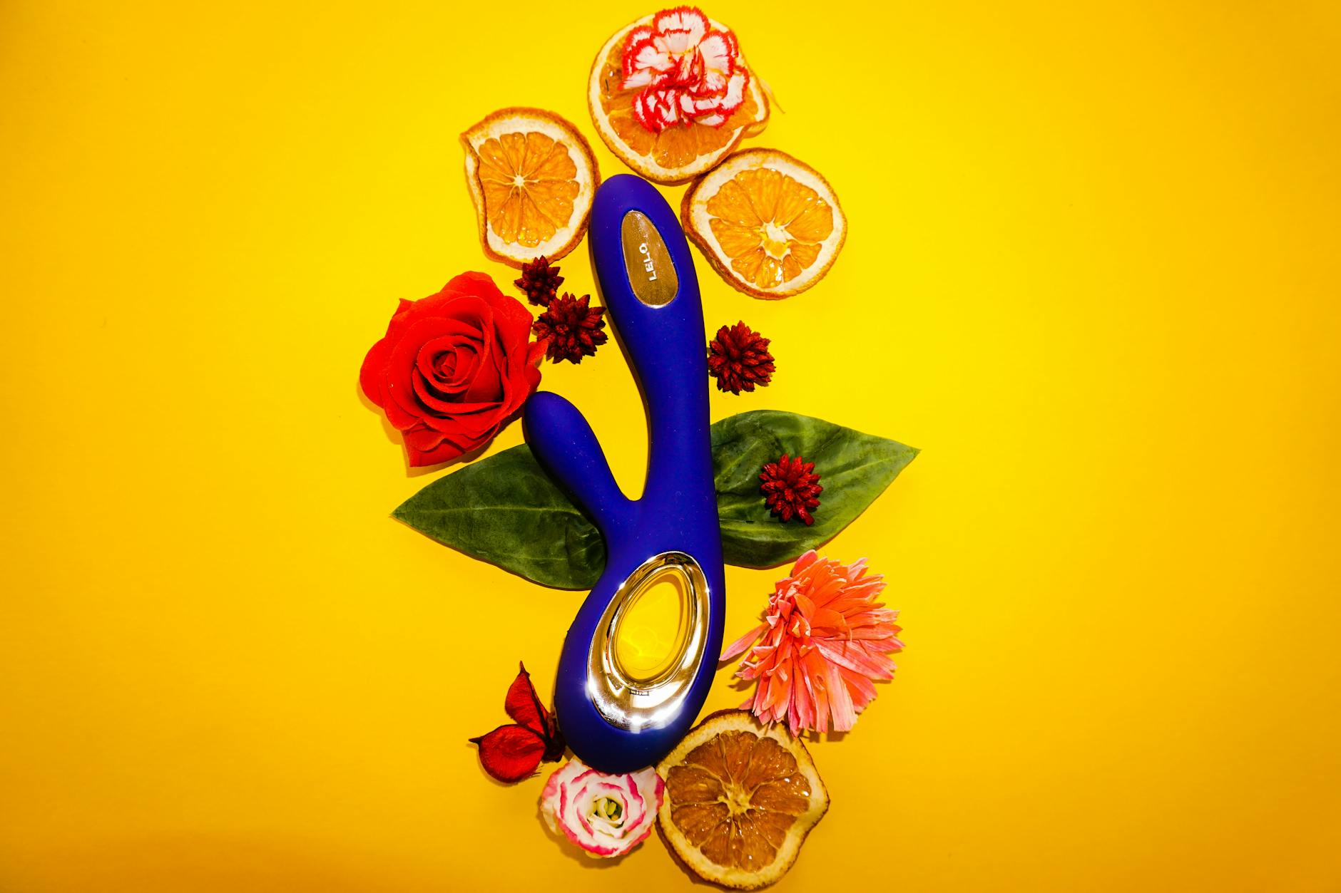 Close-up of hands holding a sleek lemon vibrator, representing modern intimacy and pleasure.